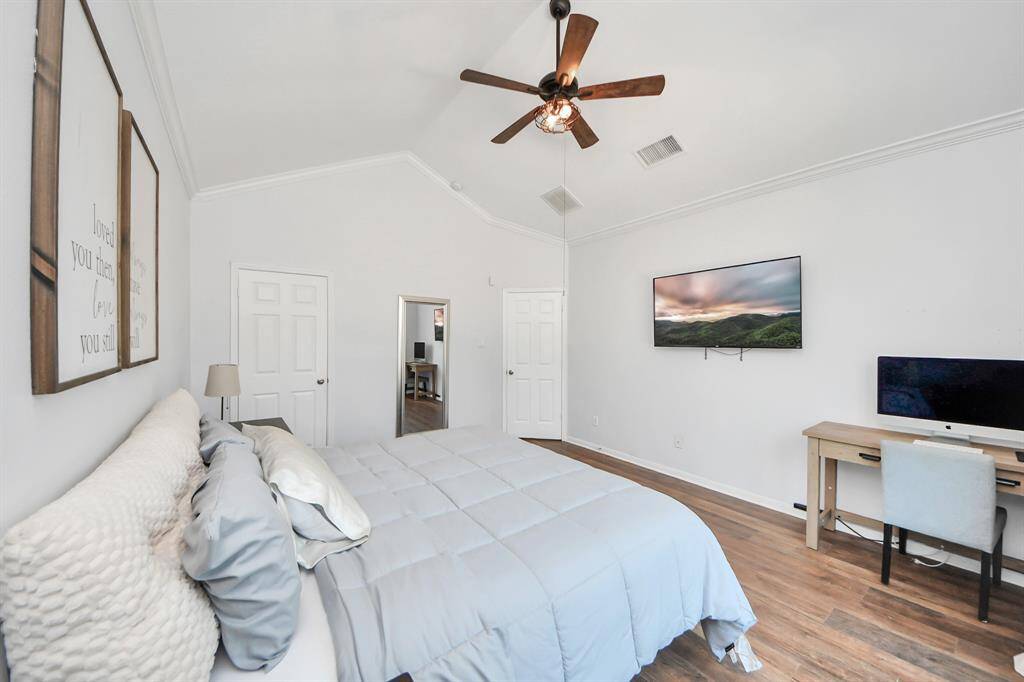 Spacious primary bedroom with vaulted ceilings and a ceiling fan!