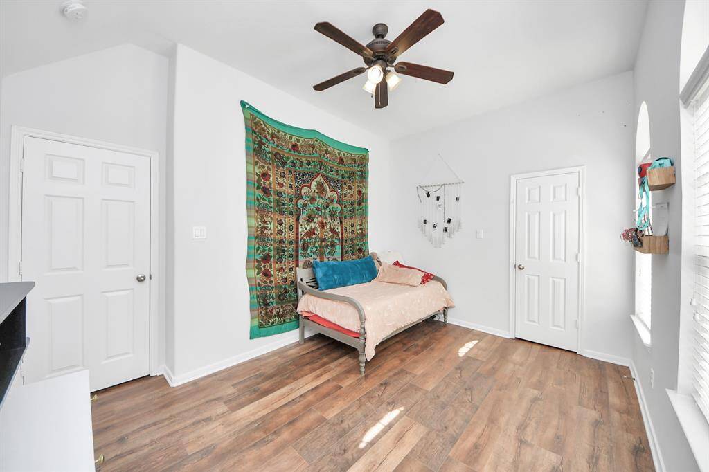 Fourth bedroom with vaulted ceilings and a ceiling fan!