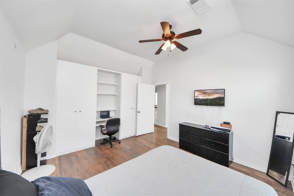 Fifth bedroom with vaulted ceilings and a ceiling fan!