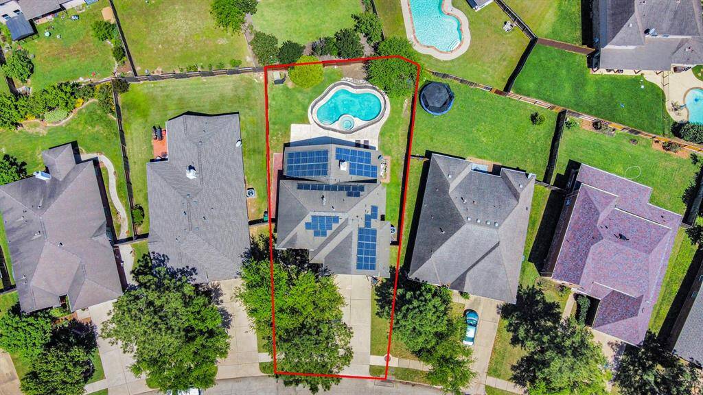 Aerial view of the home featuring paid-off solar!