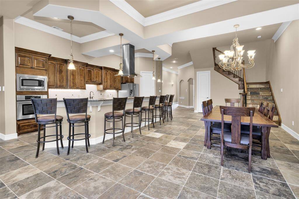 The gourmet kitchen is a chef's dream, equipped with modern appliances, ample counter space, and stylish cabinetry. The open layout is ideal for cooking while socializing with guests.