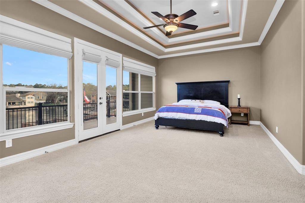 The cozy bedroom offers a peaceful retreat, complete with  a walk-in closet, ensuite bathroom, and balcony access.