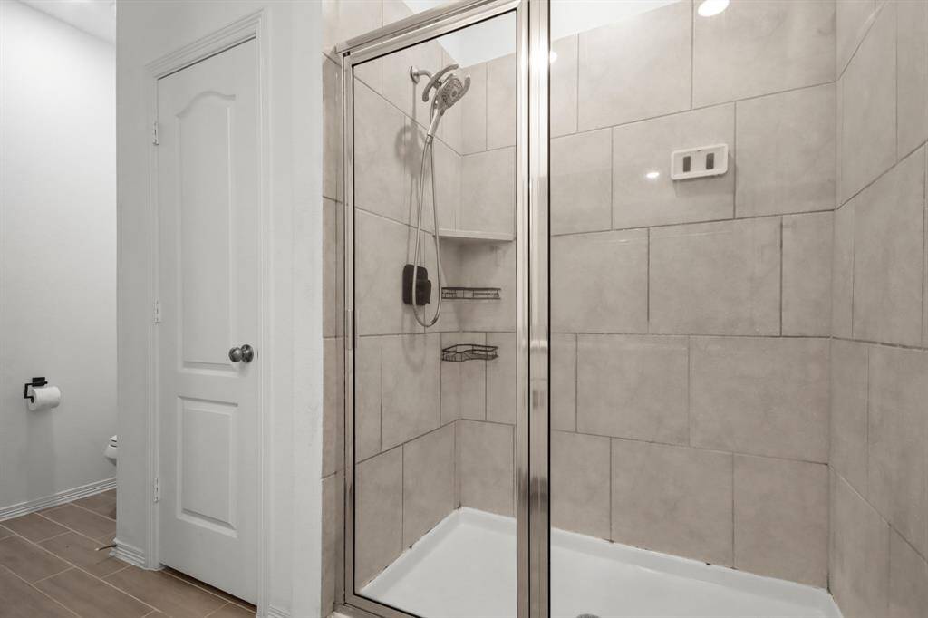 It is complete with a glass enclosed walk-in shower with gorgeous tile walls.