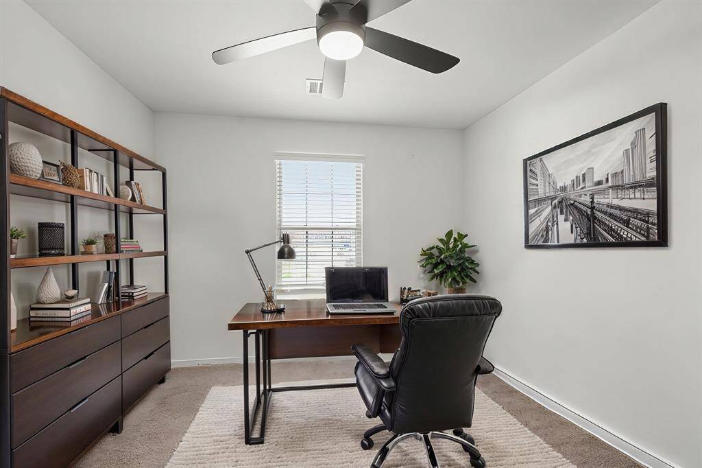 Virtually Staged: This flex space can become a secondary bedroom or a home office! It features a ceiling fan, a window with privacy blinds, and carpet floors.