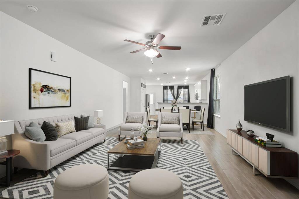 Virtually Staged: This stunning living room features tile floors, and a ceilin fan.
