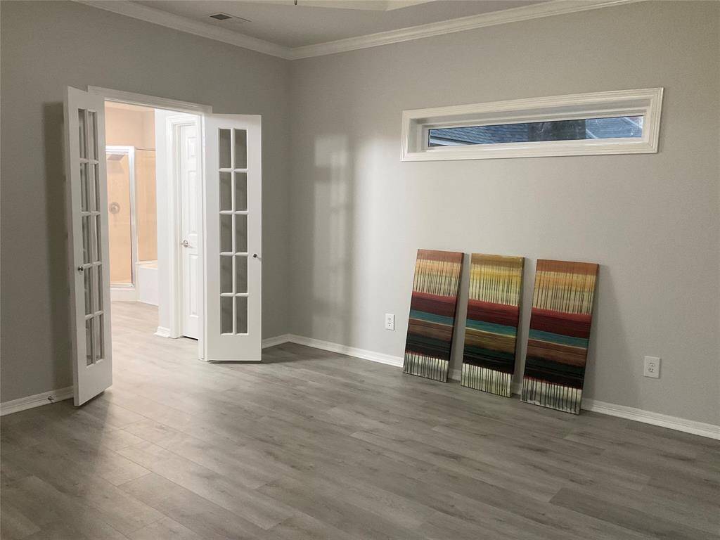 The primary bedroom is spacious, offers a recessed lighting, trim work and lots of natural lighting with new plantation shutters overlooking the lush green back yard while offering total privacy.  French doors lead to the spacious master bath with large walk in closet.