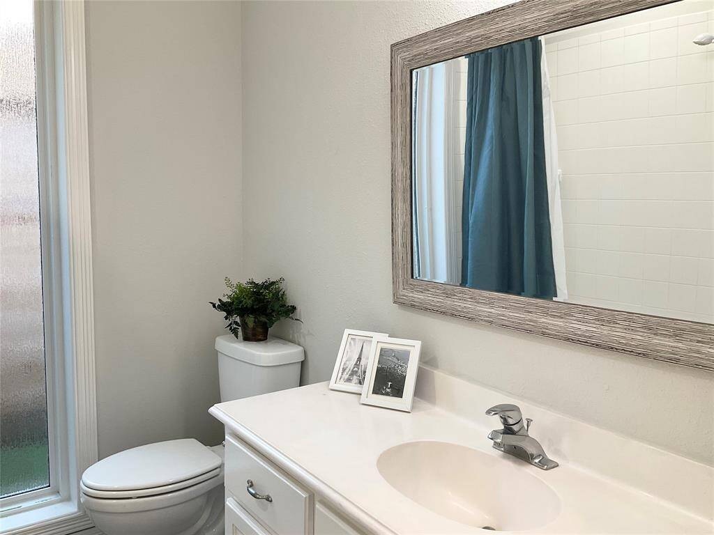 Third full bathroom located between the two secondary bedrooms on the right side of the home.  The frosted glass window offers natural light, tub shower combination, updated fixtures and a linen closet right outside of the bathroom between the 2 secondary bedrooms.