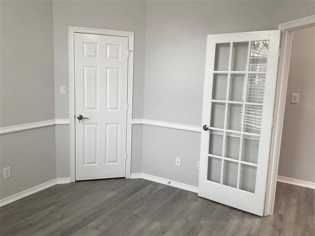 Another flexible room with a full walk in closet that offers a locked door. This can be a 4th bedroom with a full bath next door or a great home office.  The space is well-lit, with plantation shutters and a view of the front yard community.