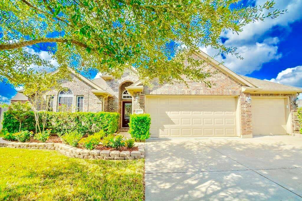 Charming brick home with a spacious driveway and two-car garage. Features a well-maintained front yard with lush landscaping and mature trees. Ideal for families seeking a welcoming neighborhood setting.