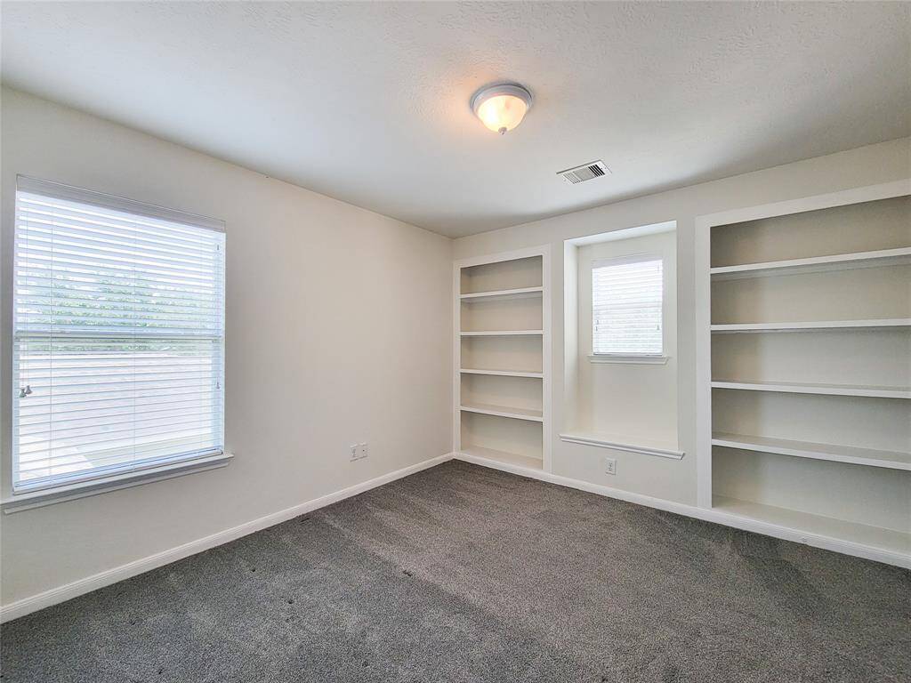 Bedroom # 3 with built-in book shelves and seating nook by the window.