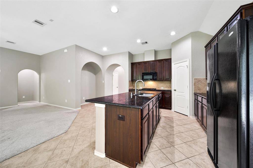 The gas cooktop and walk-in pantry are sure to please the family chef.