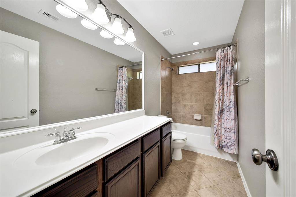 The secondary bathroom is conveniently located between the secondary bedrooms.