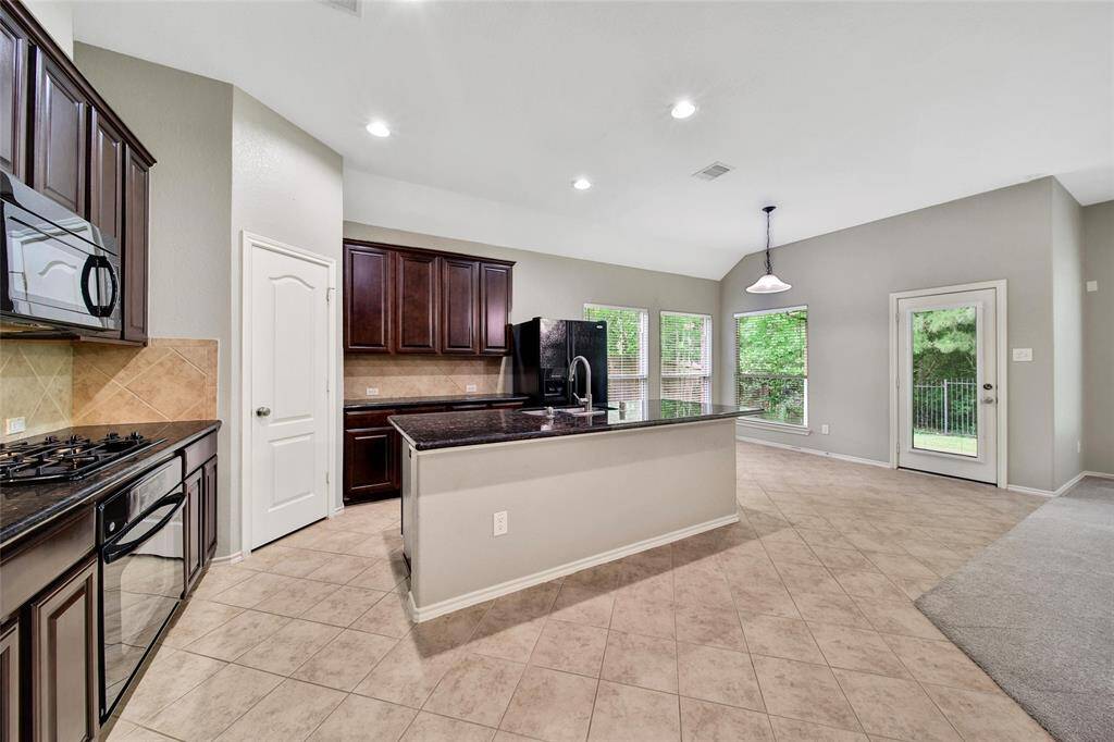 You’ll love the stunning kitchen with a large granite island.