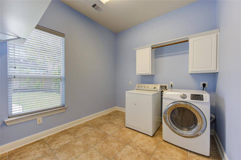 The utility room is completed with a washer and dryer and generous space for a comfortable home task.