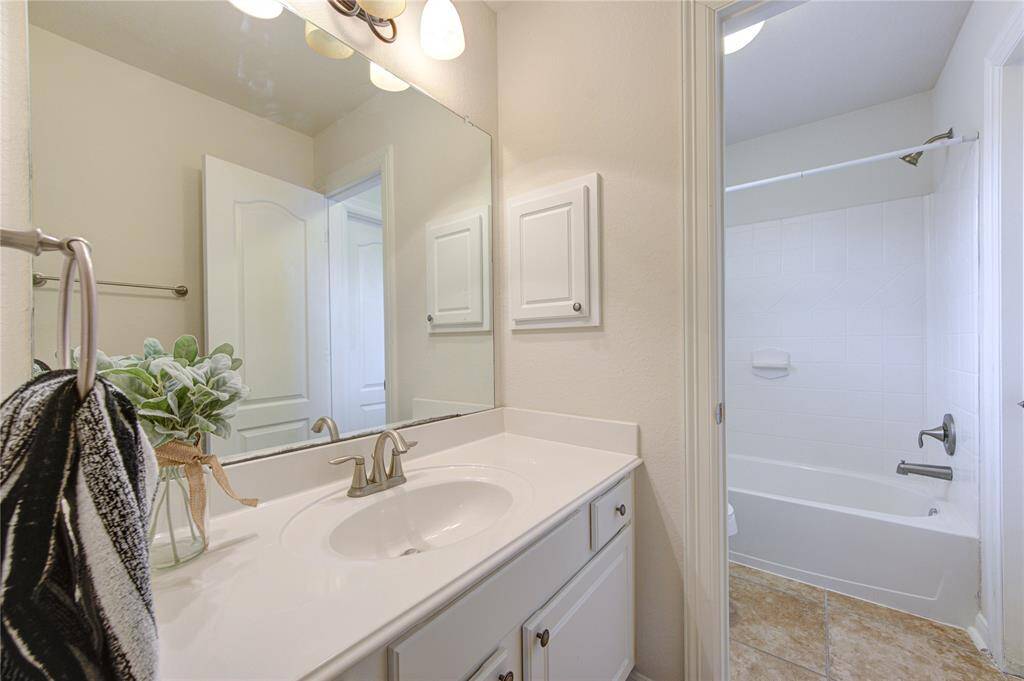 The sink and cabinet area for the 2nd bedroom. It shares the shower and toilet area with the 3rd secondary bedroom.