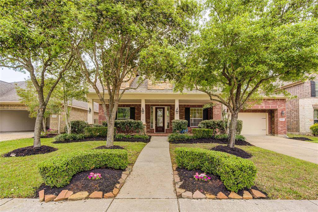 A lovely curb appeal with mature vegetation too.
