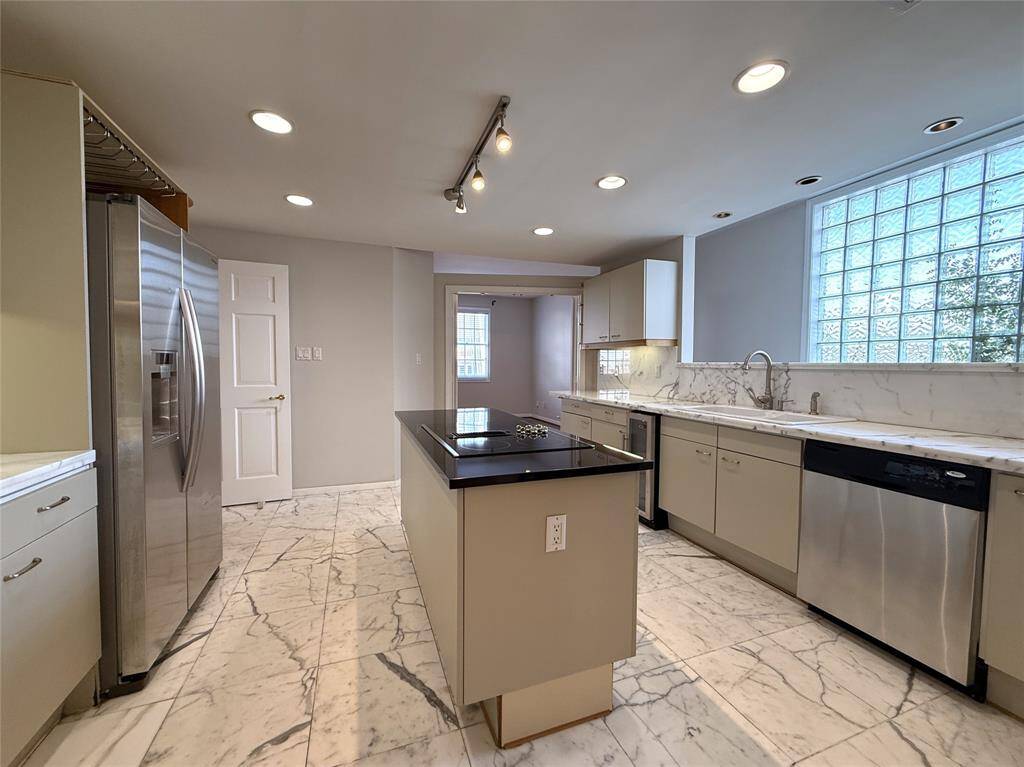 Natural night flows into the kitchen from glass block windows. Notice, there is also a beverage chiller.