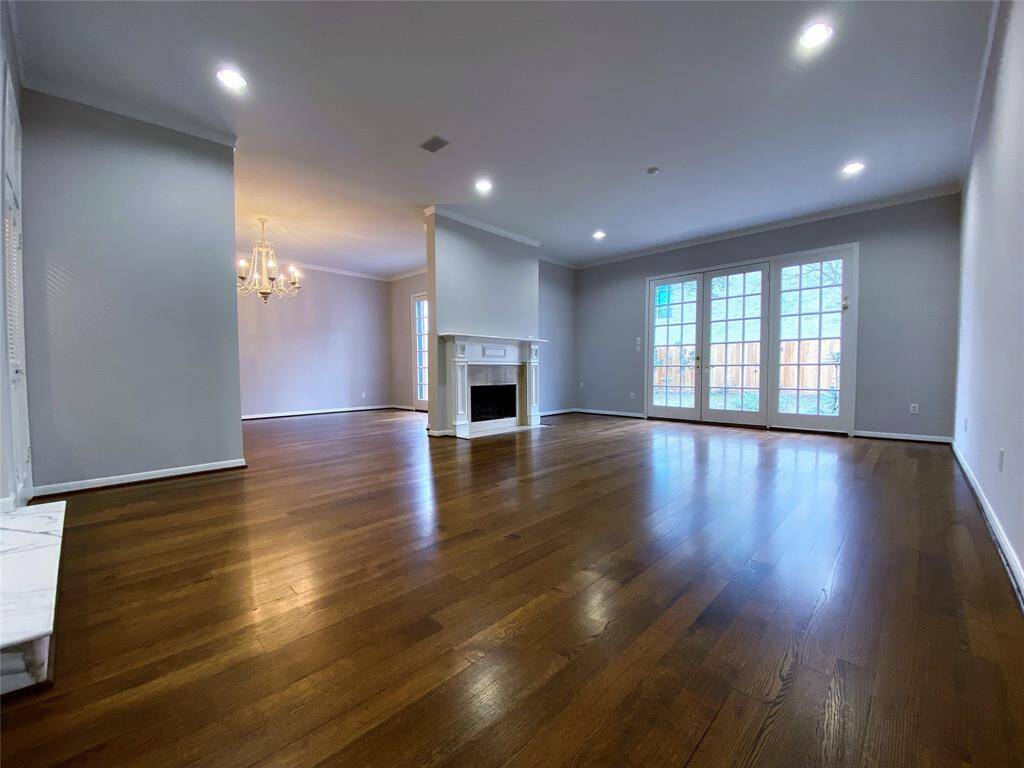 Adjoining the dining room, the living room is even more spacious and views out into the back yard. For bad weather, the living room and dining room each offer electric storm shutters.