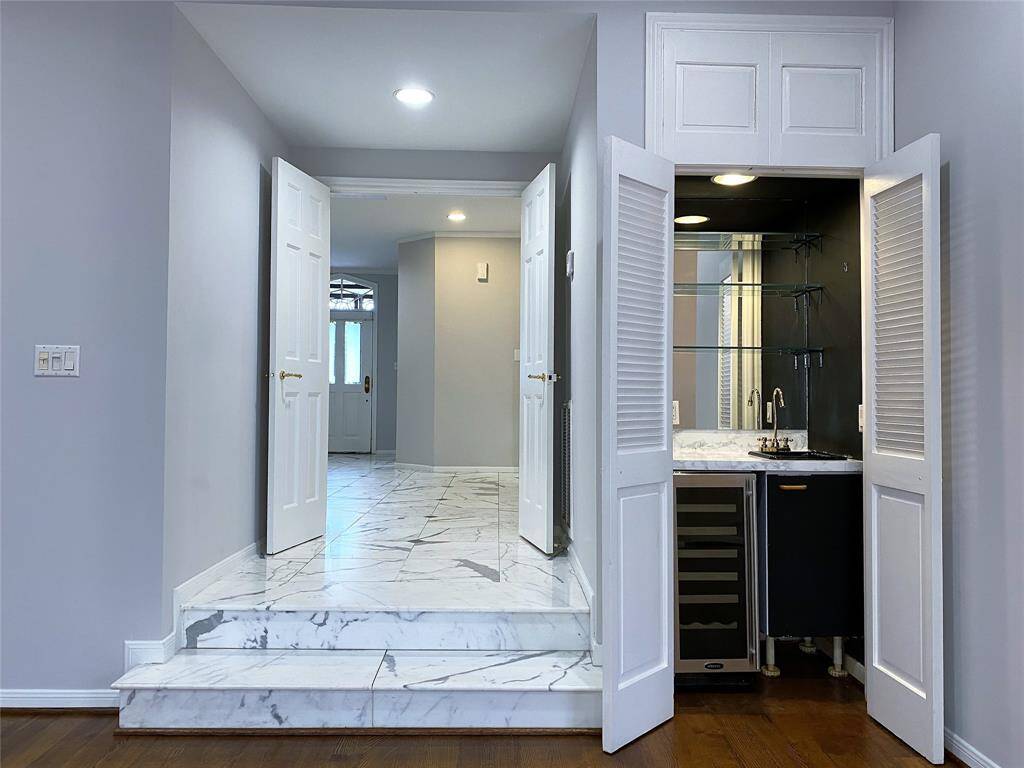 Next to the entry to the living room is a wet bar with beverage chiller.