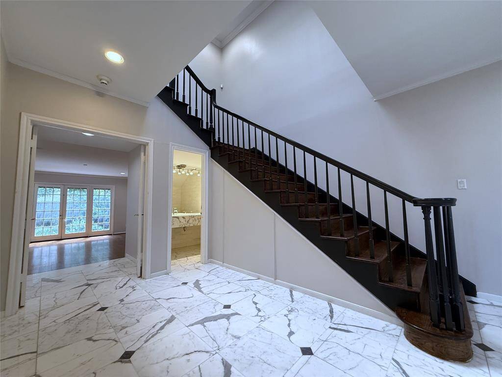 In the entry foyer & by the double doors opening into the living room is a convenient 1/2 bath.