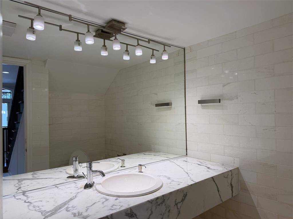 The 1/2 offers a marble counter top & tile walls.
