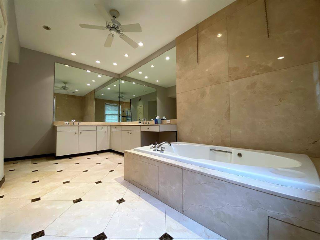 With ceiling fan, the primary bath offers double sinks, a make up vanity and a soaking tub.