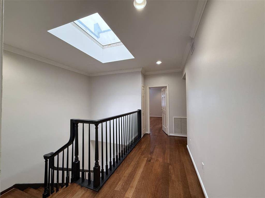 From the primary suite, the two secondary bedrooms are located at the opposite end of the home.