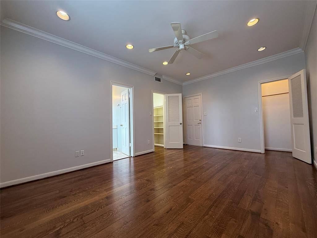 With ceiling fan and recessed lighting, the 1st secondary bedroom offers two closets and a private bath.
