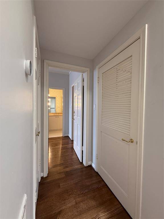 In the hallway between the 1st & 2nd secondary bedrooms, on the left is a linin closet and on the right is the laudry rooom.