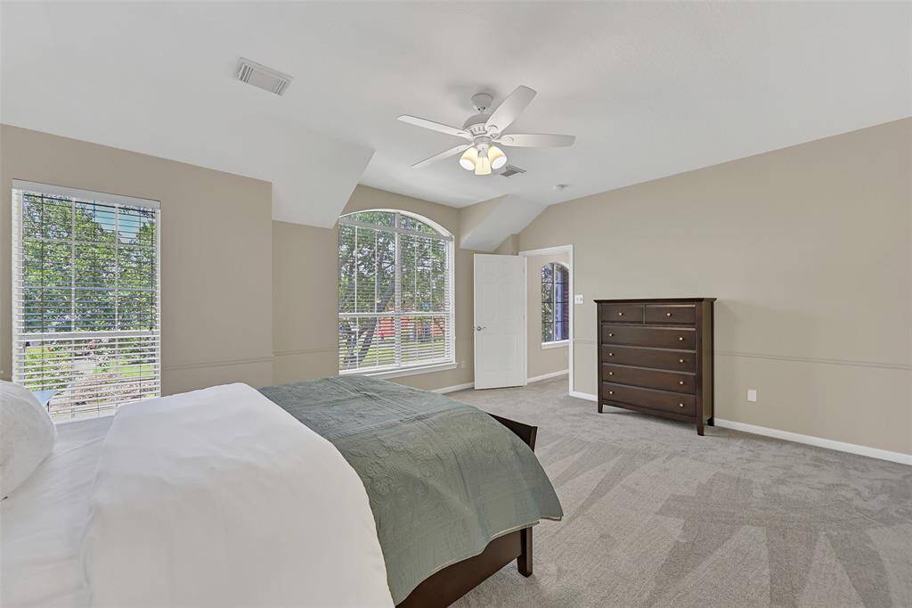 The largest of the three secondary bedrooms features fresh neutral paint, plush new carpet, a spacious walk-in closet, a lighted ceiling fan, a pair of front-facing windows shaded by 2 inch blinds, and access to a shared Jack & Jill bath.