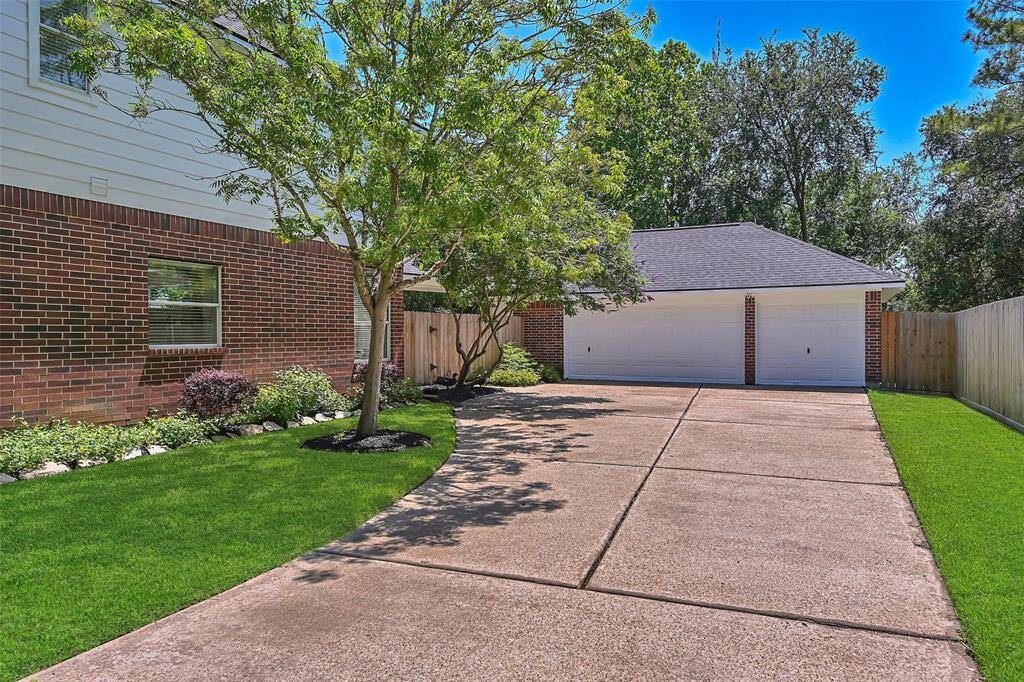 Detached 3-car garage with fresh exterior paint on both the garage and breezeway, offering ample space and a clean, updated look.