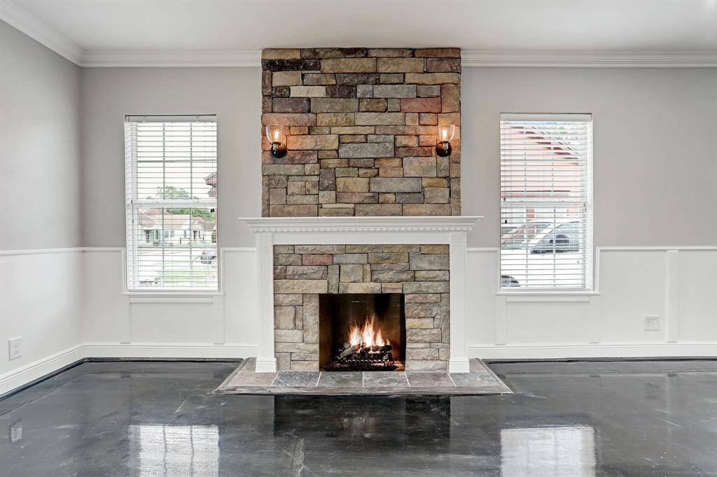 WELL APPOINTED LIVING ROOM BOASTS AN ELEGANT ENTRY DOOR, CROWN MOLDING & HEARTH!