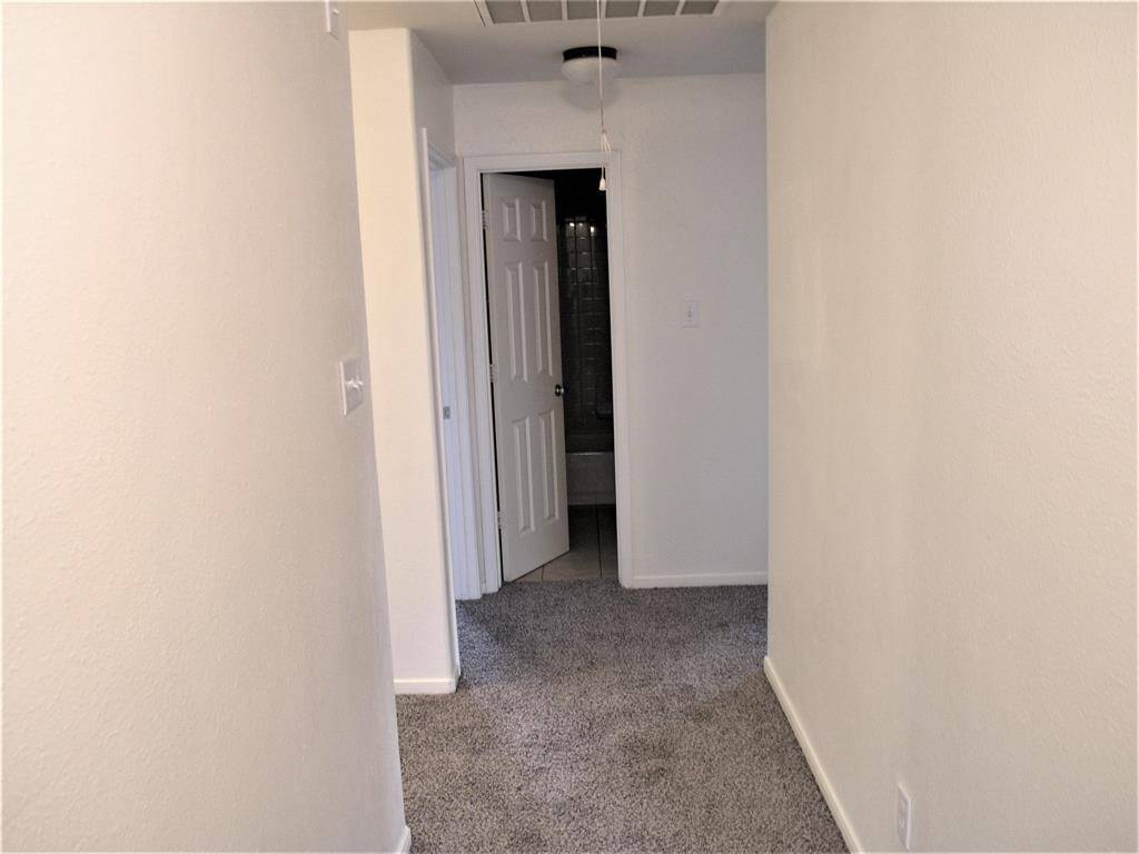 Hallway from Primary to Stairs and Bedroom 1 and 2 and upstairs Bathroom