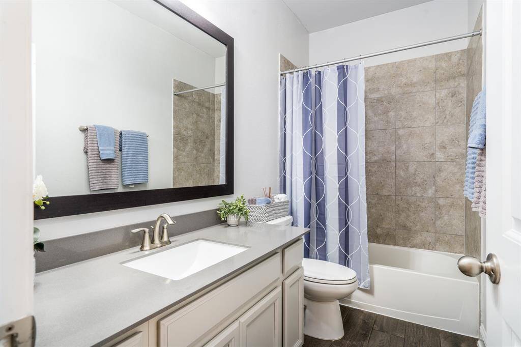 The secondary bathroom is thoughtfully designed with modern fixtures and plenty of space, making it both functional and comfortable for family or guests