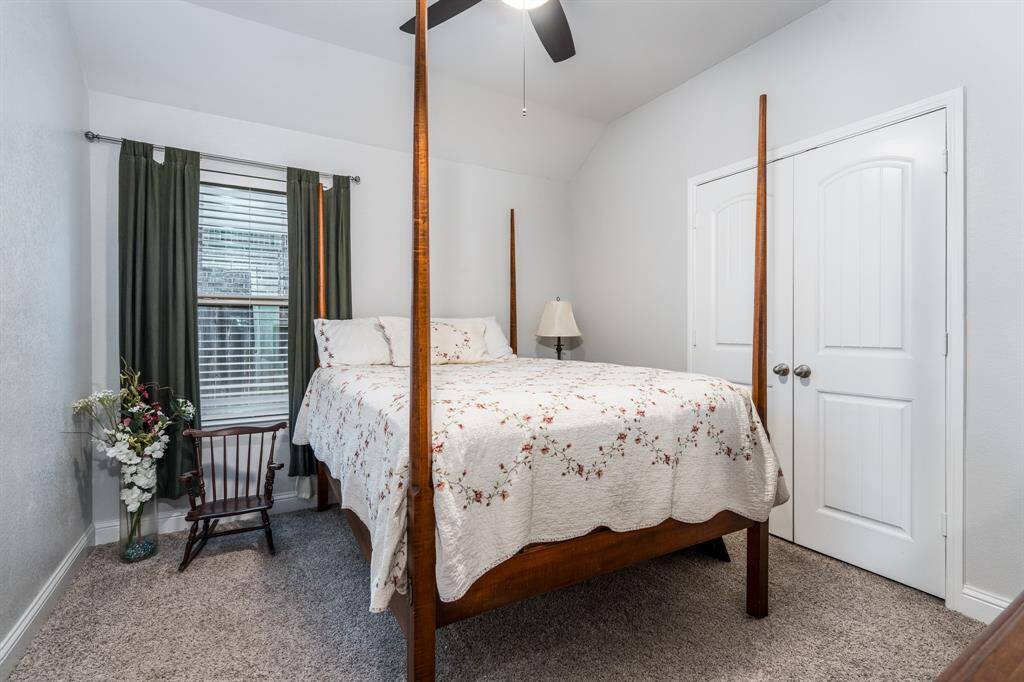 The third bedroom is filled with natural light and features lush carpeting, creating a cozy and inviting space that's perfect for rest or relaxation.