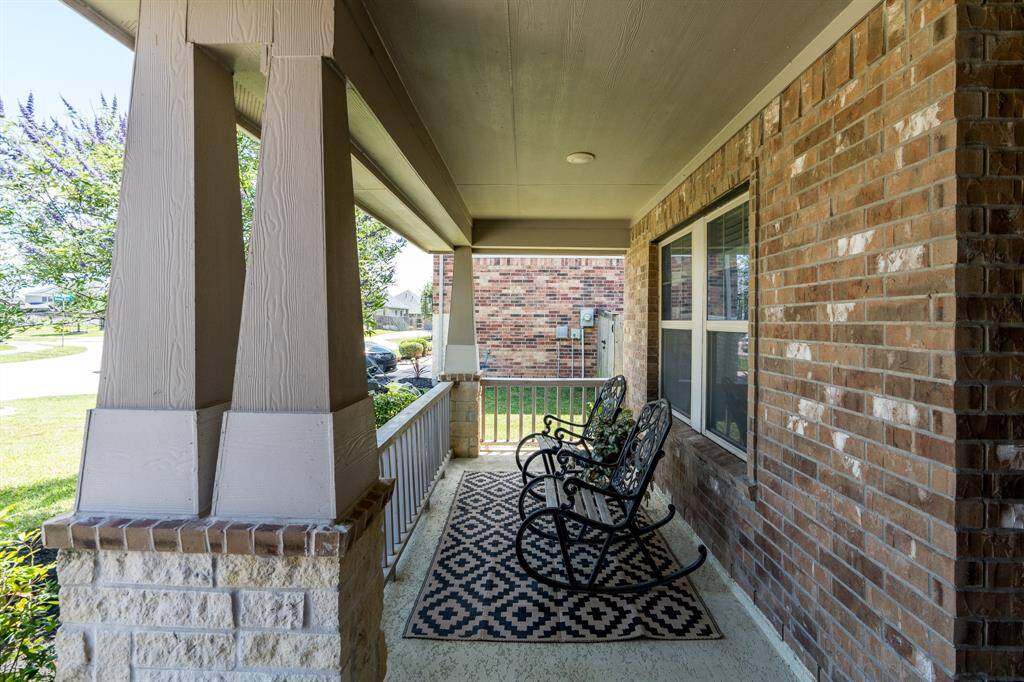 A cozy front porch greets you as you approach, offering the perfect spot to relax and take in the peaceful surroundings.