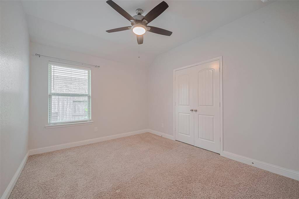 Another secondary bedroom provides a bright, comfortable space — perfect for a guest room, kids’ room.