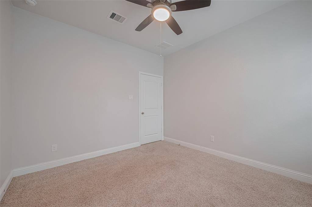 The secondary bathroom features a clean, functional layout with a tub and shower combo — perfect for family or guests.
