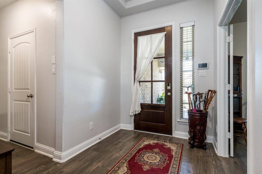 As you step inside, take a moment to admire the beautiful front door that sets the tone for the elegance found throughout the home
