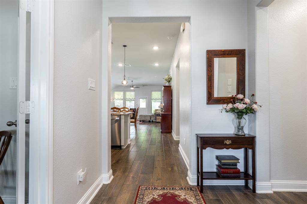 As you enter through the front door, your eyes are immediately drawn to the spacious family room and the impressive wall of windows at the back of the home, filling the space with natural light.