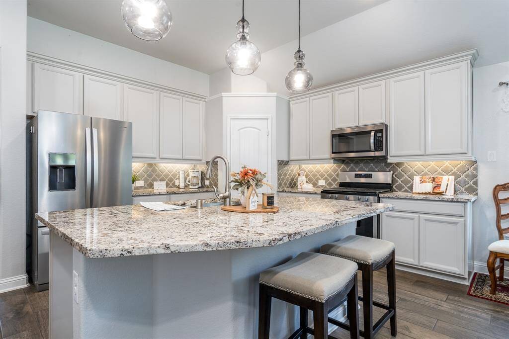 Step into the stunning kitchen, featuring under-cabinet lighting that adds both style and functionality to the space