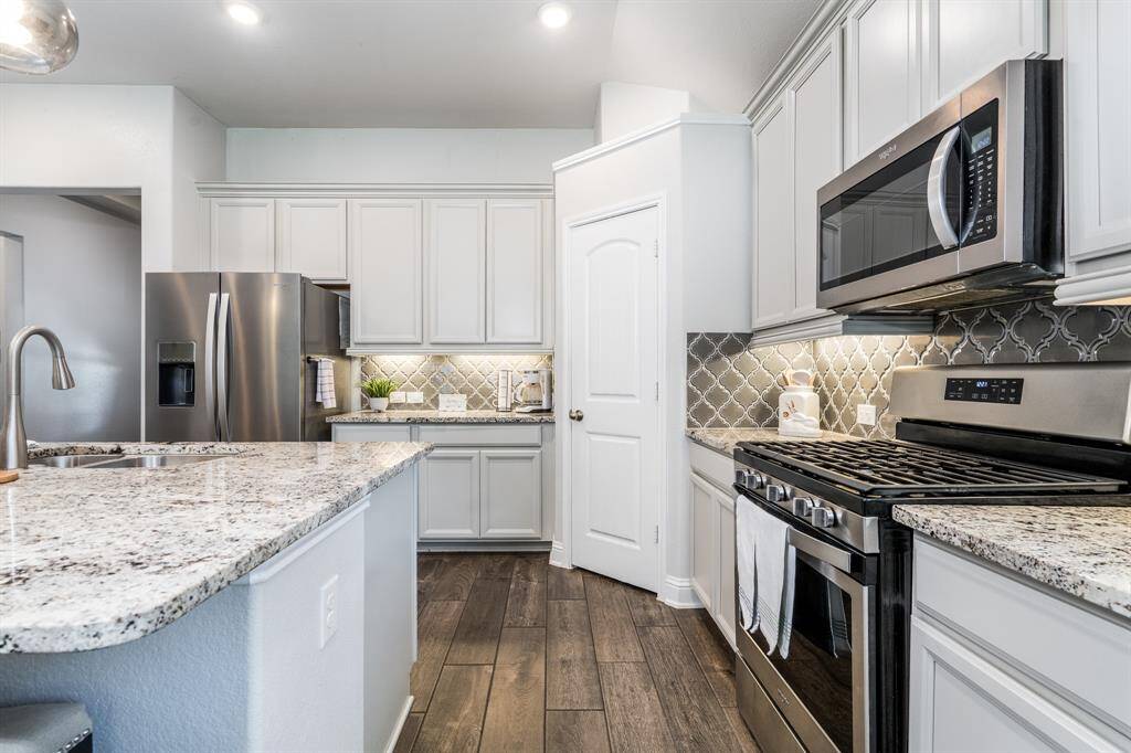 The kitchen offers an abundance of counter space and cabinetry, providing both functionality and ample storage for all your culinary needs