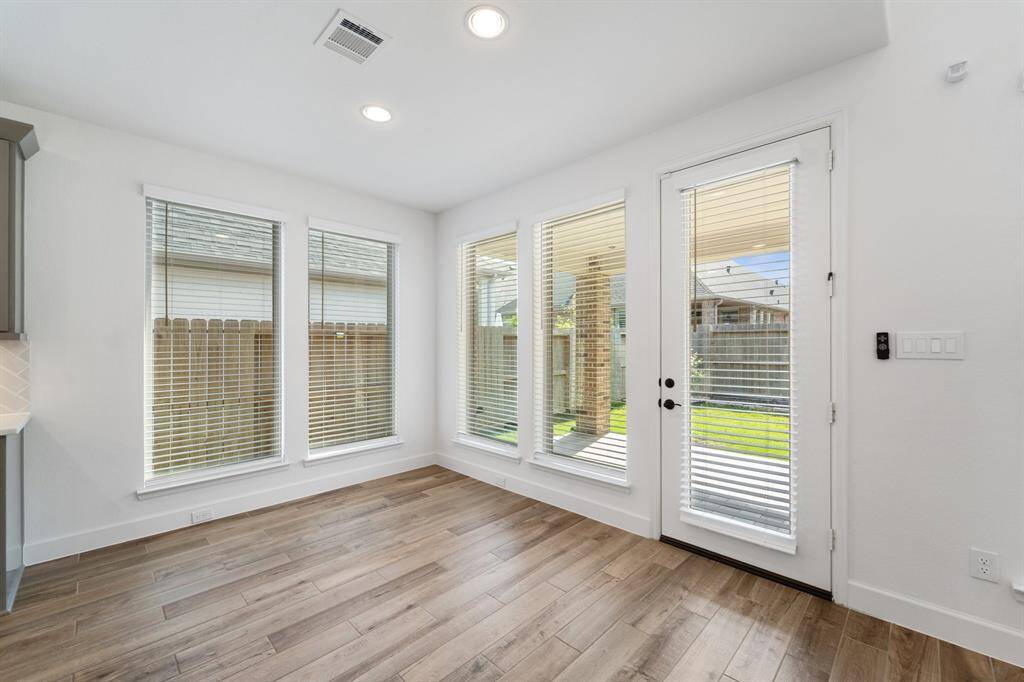 Breakfast nook next to kitchen looks out to living room