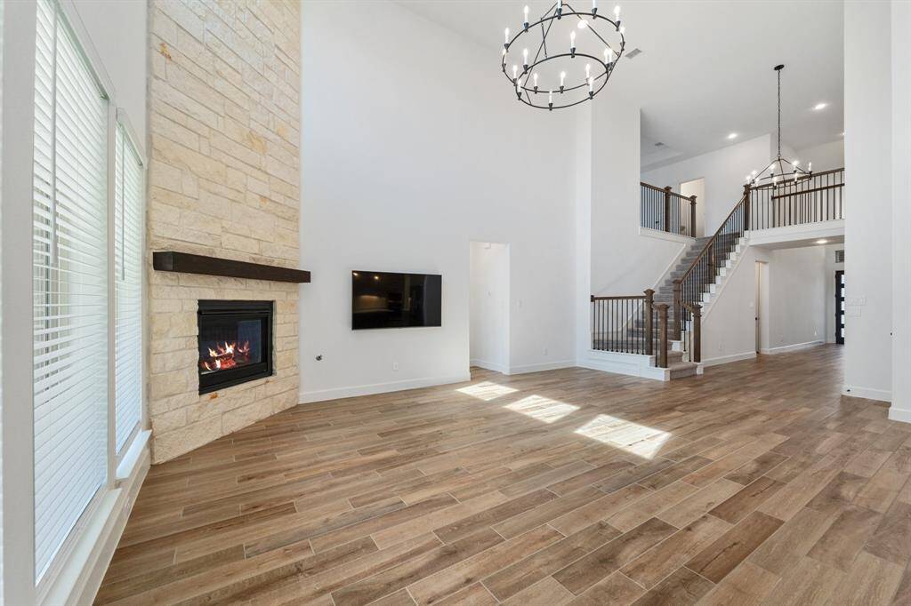 Grand staircase does NOT flow out to the front door. Elegant railing and lighting.