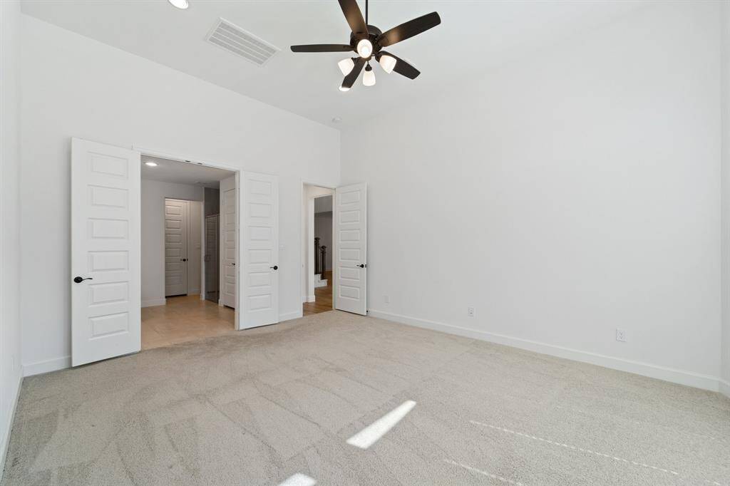View into primary bath and out the door to the living room area from Primary bedroom.