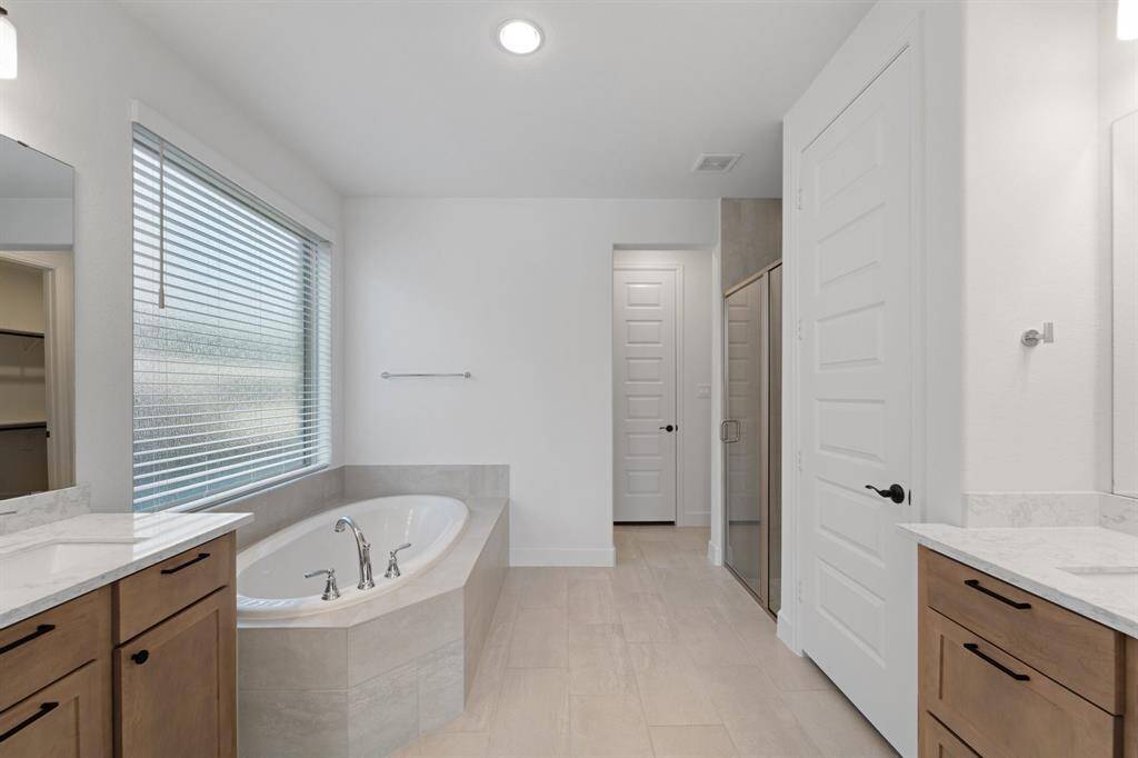 Separate vanities and elegant subtle colors invite you into the spa like retreat.