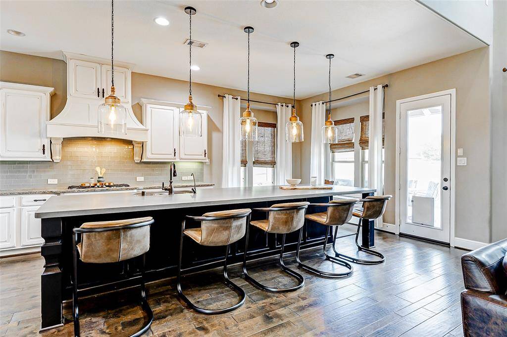 At the heart of the home, this stunning kitchen features a spacious, well-designed layout perfect for entertaining. The showstopper? A magnificent 13.5-foot island with seating for many, providing an ideal spot for gathering with friends and family.