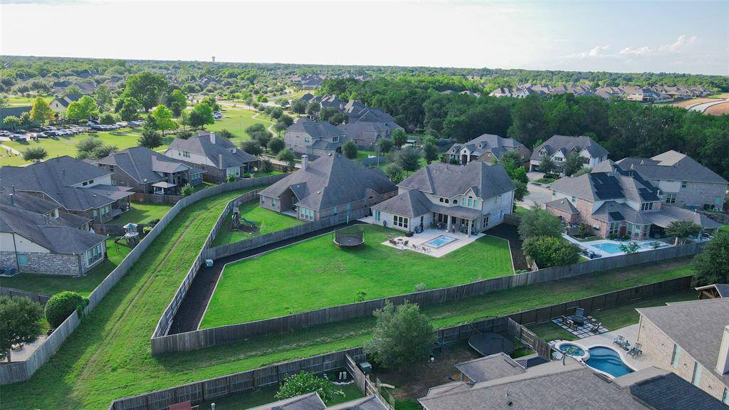 Enjoy enhanced privacy with no direct neighbors behind and serene greenspace flanking both sides of your fully fenced backyard—creating a peaceful, secluded retreat. Thoughtfully bordered landscaping lines the perimeter of the backyard.