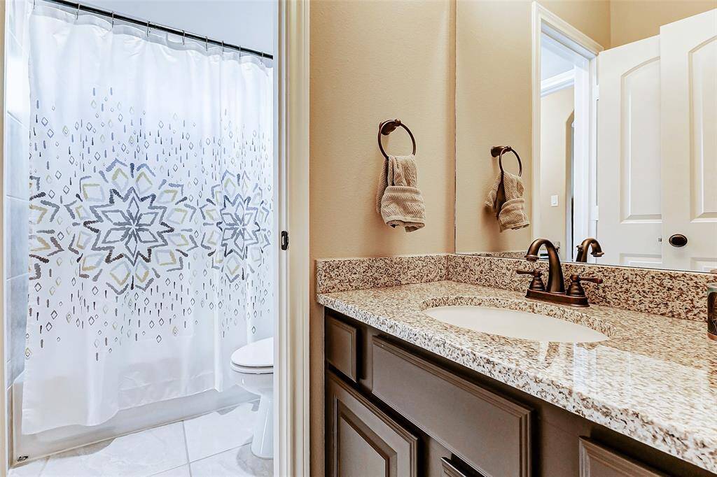 Each bedroom is complemented by its own private bathroom, featuring a vanity and a tub/shower combination, ensuring comfort for every resident.