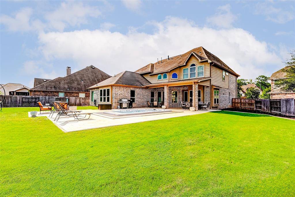Let’s take another look outside—you’ll want to spend all your time here! With ample decking for comfortable lounging and plenty of green space for kids to play, pets to roam, and endless outdoor enjoyment, this backyard truly has it all.